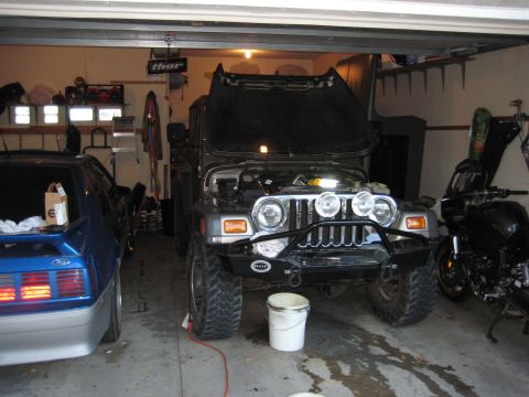 2005 Jeep Wrangler - Jeep Wrangler in a garage, hood up, next to a Mustang and a motorcycle.