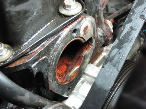 2005 Jeep Wrangler - The thermostat housing shows significant rust and corrosion around the opening.