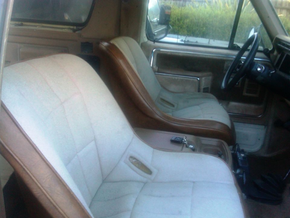 Interior view of 1986 Ford Bronco showing front bucket seats and dashboard