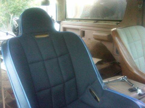 1986 Ford Bronco - Interior view of dark blue bucket seats with light blue piping.