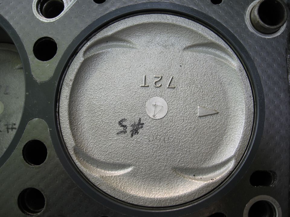 Piston with markings '72T' and '#5', part of an engine cylinder