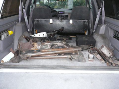 1988 Ford Bronco - Various suspension and chassis parts are stored in the cargo area of this vehicle.