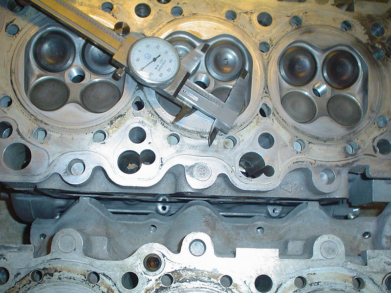 Engine cylinder head with valves and a caliper measuring tool on top