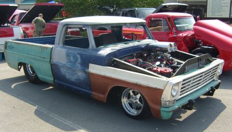 2007 Ford Mustang - This customized 1967 Ford pickup truck features a unique multi-color paint scheme and a prominent exposed engine with a scoop.