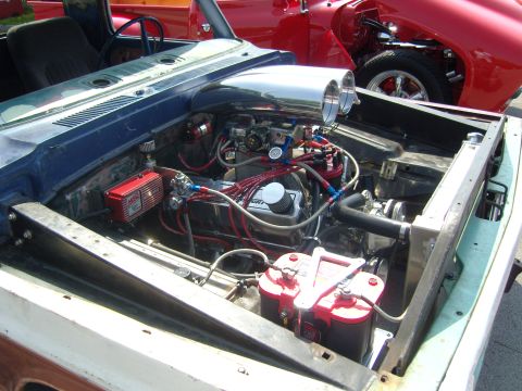 2007 Ford Mustang - Custom engine bay with performance modifications, including dual carburetors and a prominent air intake.