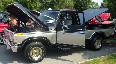 2007 Ford Mustang - This two-tone pickup truck has its hood and driver's door open, revealing the engine and interior.