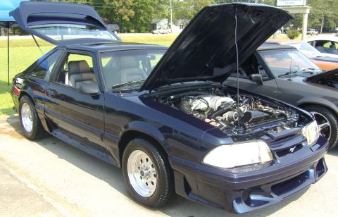 2007 Ford Mustang - This dark blue Ford Mustang hatchback has its hood and trunk open, revealing the engine bay and interior.