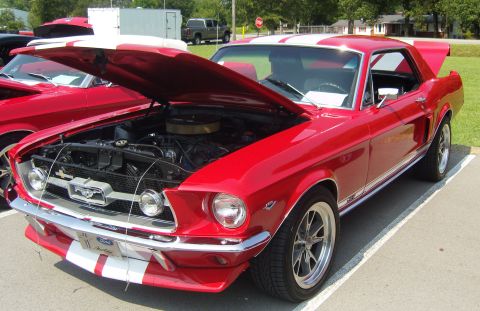 2007 Ford Mustang - This red 1967 Ford Mustang coupe features white racing stripes and its hood is open to display the engine.