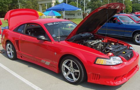 2007 Ford Mustang - A red Saleen Mustang is displayed with its hood and trunk open at an outdoor event.