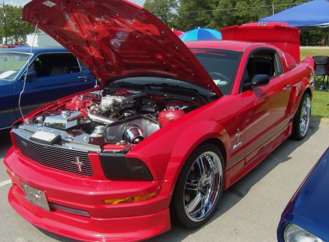 2007 Ford Mustang - Red 2007 Ford Mustang at a car show, hood raised to display the engine bay.