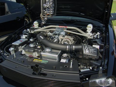 2007 Ford Mustang - Engine bay of a 2007 Ford Mustang features a Roush supercharger and decorative skulls.