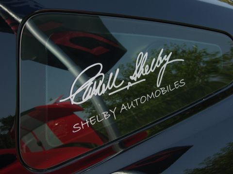 2007 Ford Mustang - A close-up of a car's rear window displays a Shelby Automobiles decal and a signature.