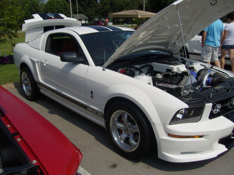 White 2007 Ford Mustang Shelby GT500 with hood open, showing engine modifications