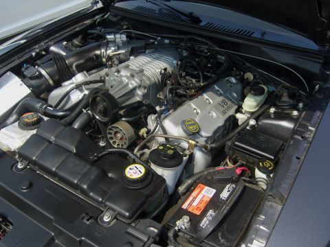 2007 Ford Mustang - Close-up of a Ford V8 engine, likely from a Mustang, a supercharger and V8 32-valve badging.
