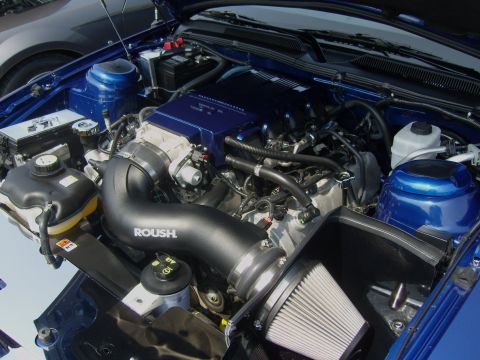 2007 Ford Mustang - Engine bay of a blue 2007 Ford Mustang a Roush intake system and supercharger.