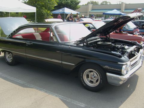 2007 Ford Mustang - A classic black 1960 Ford Starliner is displayed with its hood open at an outdoor car show.
