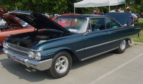 2007 Ford Mustang - A dark teal 1960 Ford Fairlane coupe is displayed with its hood and trunk open at an outdoor event.