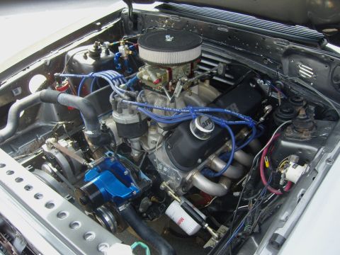 2007 Ford Mustang - The engine bay of a car, showing a V8 engine with various components and wiring.