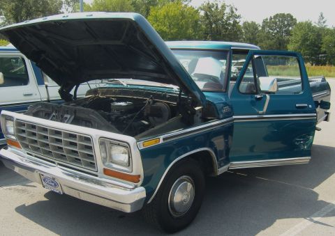 2007 Ford Mustang - A teal Ford F-Series truck from the 1970s is shown with its hood and driver's door open.