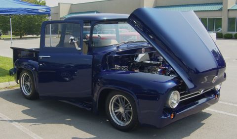 2007 Ford Mustang - Customized 1956 Ford F-100 pickup truck displayed with its hood open.