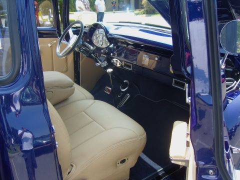 2007 Ford Mustang - The interior of a classic pickup truck features tan leather seats and a dark blue dashboard.