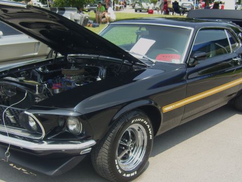 2007 Ford Mustang - This black 1969 Ford Mustang Mach 1 is displayed with its hood open, revealing the engine bay.
