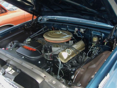 2007 Ford Mustang - The engine bay of a vintage automobile, a V8 engine with gold accents and a prominent air filter.