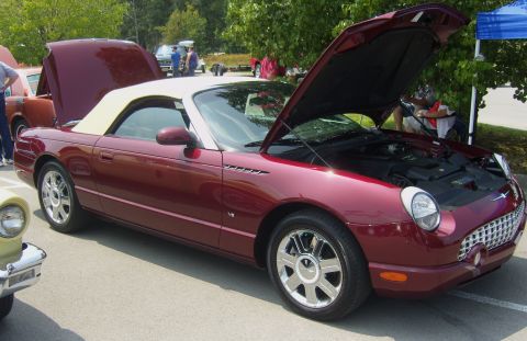 2007 Ford Mustang - A maroon Ford Thunderbird convertible with its hoods open, parked outdoors.