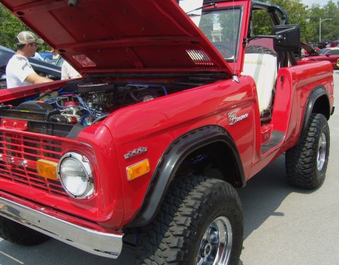 2007 Ford Mustang - This red Ford Bronco is displayed with its hood open, revealing the engine compartment.