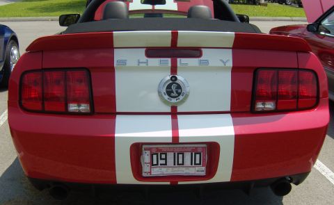 2007 Ford Mustang - Red 2007 Ford Mustang convertible with Shelby badging and racing stripes.