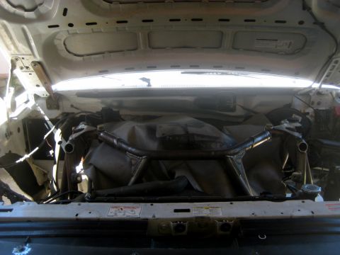 1996 Ford Bronco - Engine bay view of a 1996 Ford Bronco, showing a custom brace in the front suspension area.