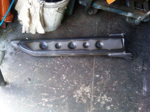 1986 Ford Bronco - A custom-made radius arm, likely for off-road use, is shown in a workshop setting.