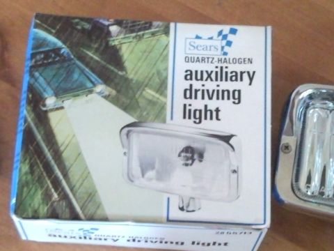 1988 Chevrolet Suburban - A box and a chrome-bezeled auxiliary driving light are displayed, with text indicating they are Sears Quartz-Halogen products.