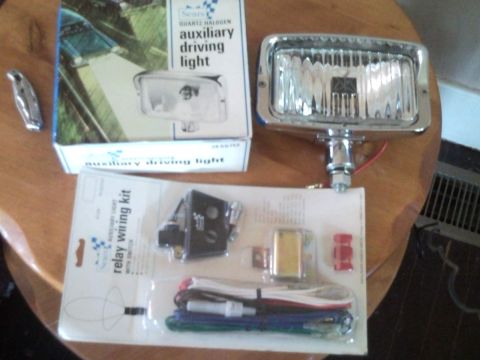 1988 Chevrolet Suburban - A new Sears auxiliary driving light and its associated wiring kit are displayed on a table.