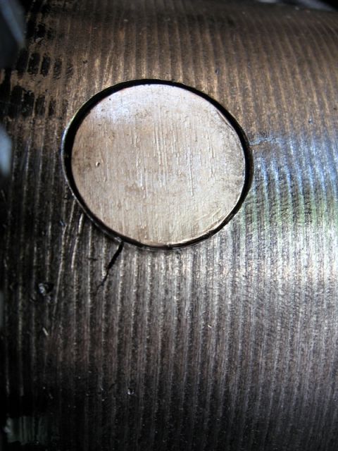 1995 Ford F-150 - A close-up view of a metal component, possibly from a vehicle's drivetrain, showing wear and a crack.