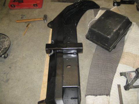 1996 Ford Bronco - Black metal winch bumper assembly with hammer, red toolbox, and other parts.