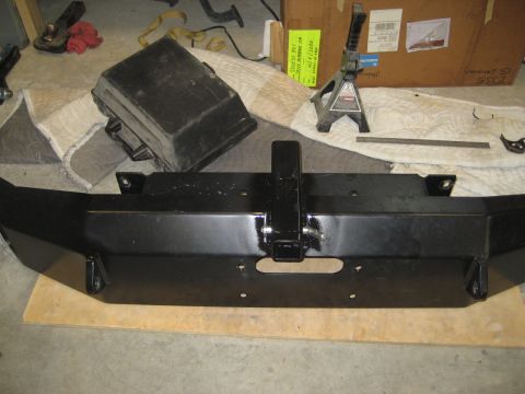 1996 Ford Bronco - This is a close-up of an aftermarket front bumper, likely for an off-road vehicle, with a receiver hitch and winch mounting provision.