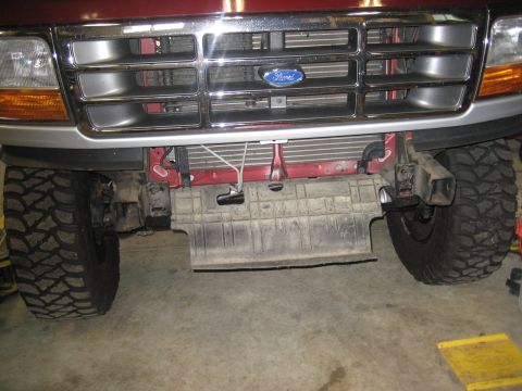1996 Ford Bronco - Front view of a red Ford Bronco with a chrome grille and off-road tires.