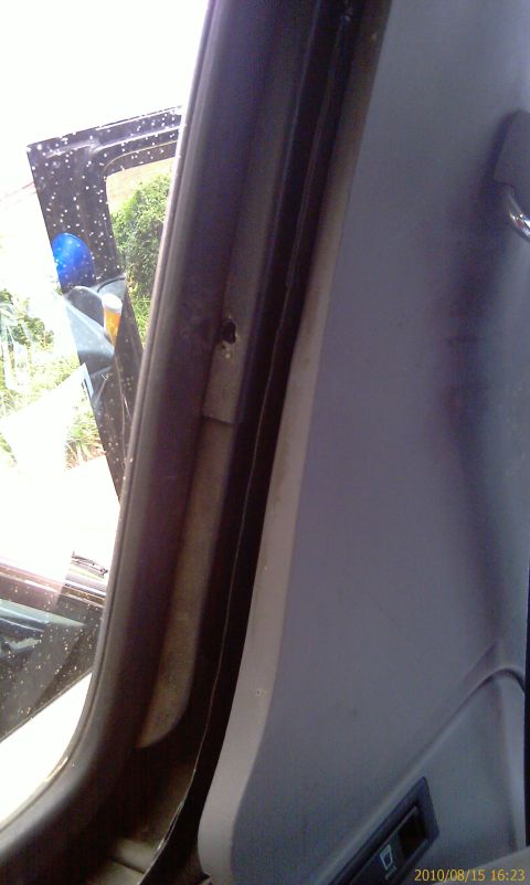 1994 Ford Bronco - Close-up view of the interior door frame and panel, showing wear and tear.