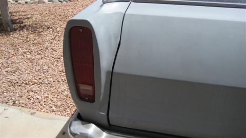 1968 Ford Ranchero - This photo shows the rear corner of a vehicle, focusing on the tail light and a dented body panel.