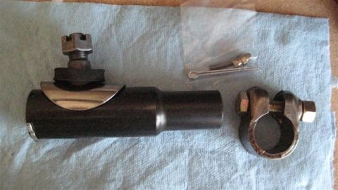 1968 Ford Ranchero - A tie rod end and a clamp are laid out on a blue cloth, with a cotter pin and hardware nearby.