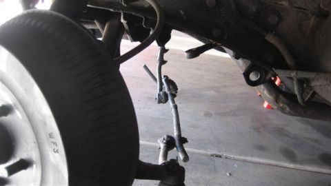 1968 Ford Ranchero - Close-up view of vehicle suspension components and a tire.