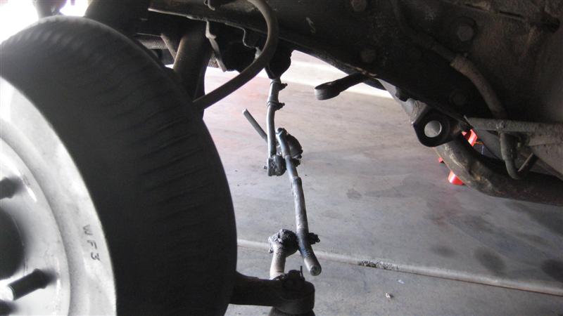 Vehicle suspension parts with a tire and wheel visible