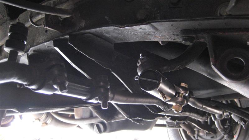 Underside view of a vehicle's steering linkage with tie rods and ball joints