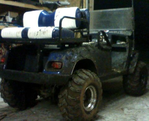 1978 Ford F-150 - This heavily modified golf cart features oversized tires and a rack holding two large barrels, suggesting it's built for off-road or utilit…