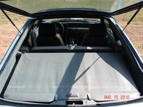 1987 Ford Bronco - Interior view of a 1987 Ford Mustang hatchback, showing front seats and cargo area.