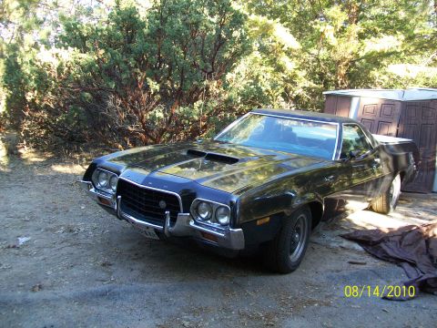 1972 Ford Ranchero - This 1972 Ford Ranchero features a black paint job and prominent hood scoops.
