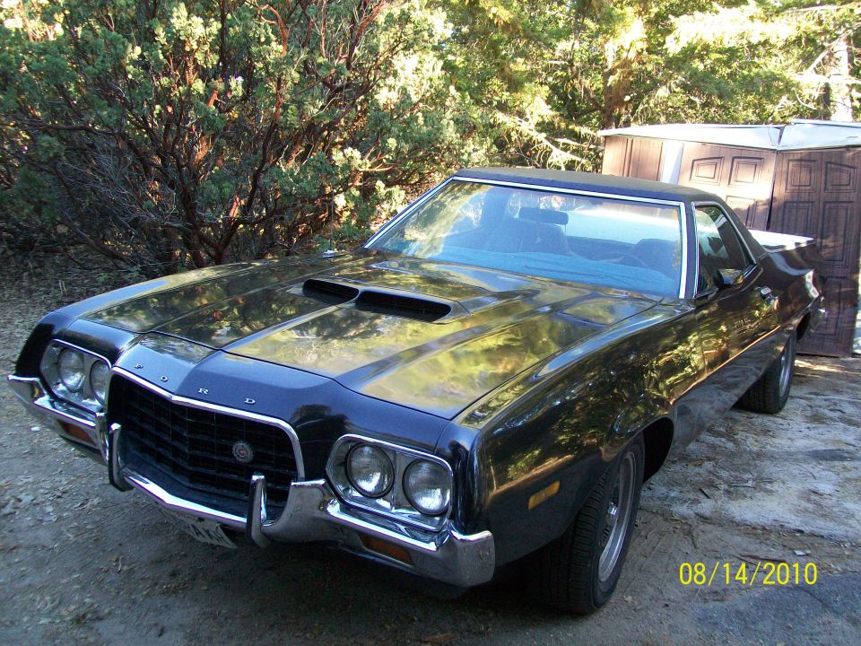 Black Ford Ranchero front three-quarter view with hood scoops after fresh paint
