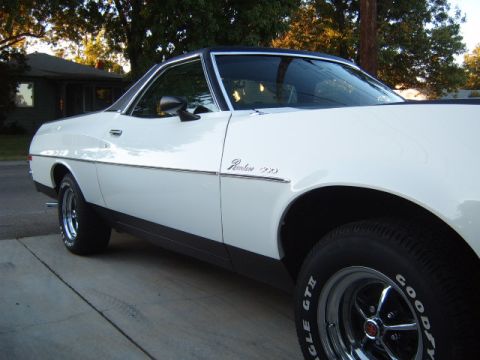 1973 Ford Ranchero - This 1973 Ford Ranchero 500 features a two-tone paint scheme with a black vinyl roof and prominent chrome side trim.