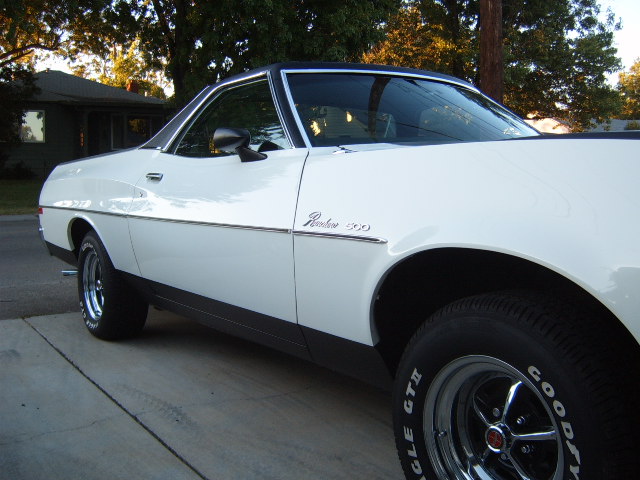 White 1973 Ford Ranchero 500 side view with chrome trim and black vinyl top